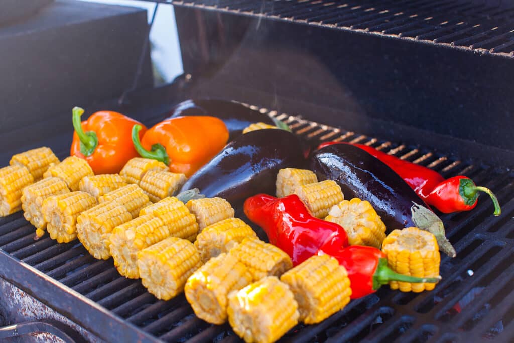 Vegetarian barbecue and cobs of corn on the grill outdoors